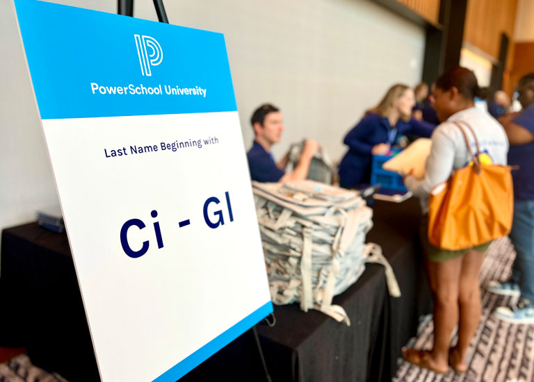 Attendee checking in at a PowerSchool University event.